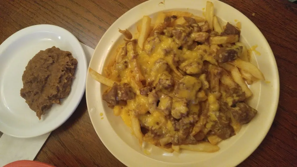 French Fries Topped with Guisado and a Side of Beans